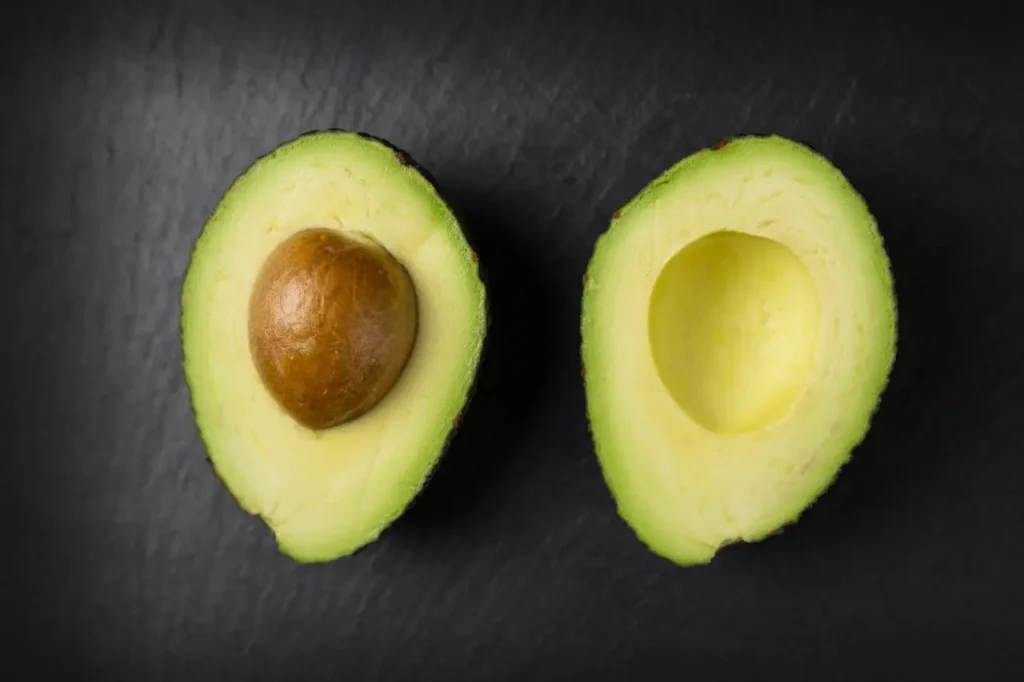 Two parts of avocado fruit after cutting